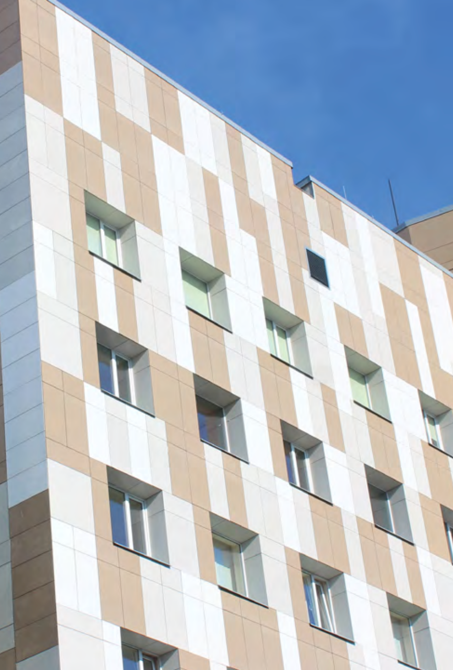 Apartment building exterior clad with StoVentec rainscreen system using fiber cement panels in white and beige, offering durable, weather-resistant, and architecturally modern finishes for multi-family residential construction in Atlantic Canada