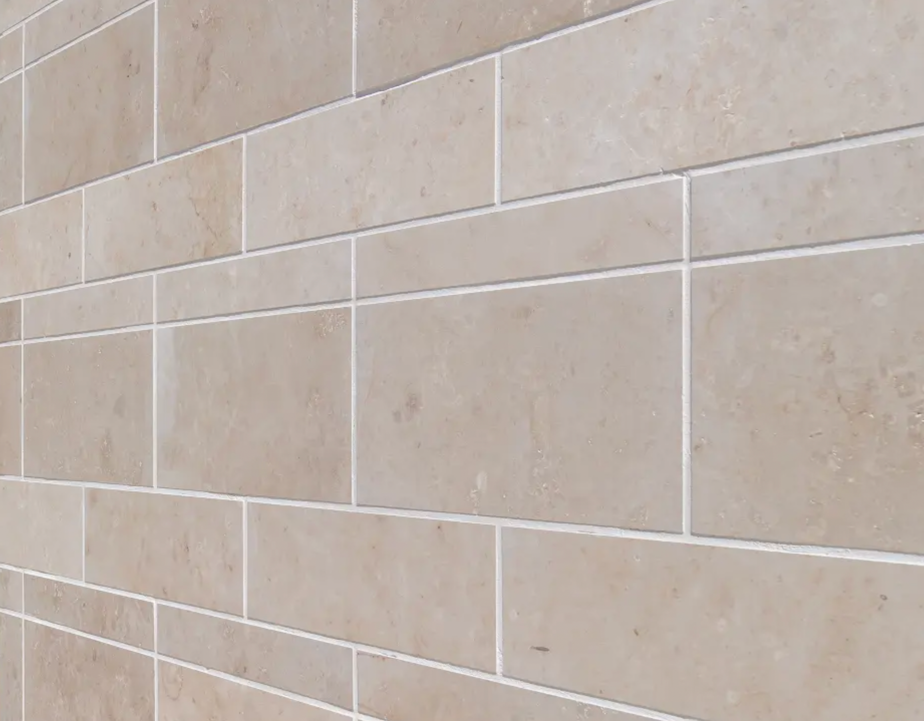 Detailed close-up image of StoVentec Natural Stone finish showcasing a block-like texture and pattern, ideal for durable architectural rainscreen facades