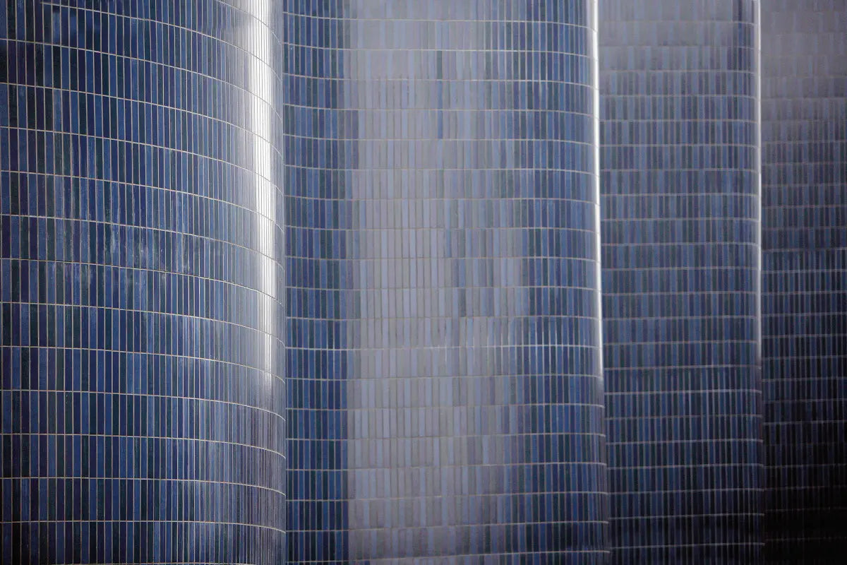 Architectural façade featuring a tall, curving wall clad in StoVentec ceramic tiles, showcasing advanced rainscreen design with elegant wave-like form and durable exterior performance.