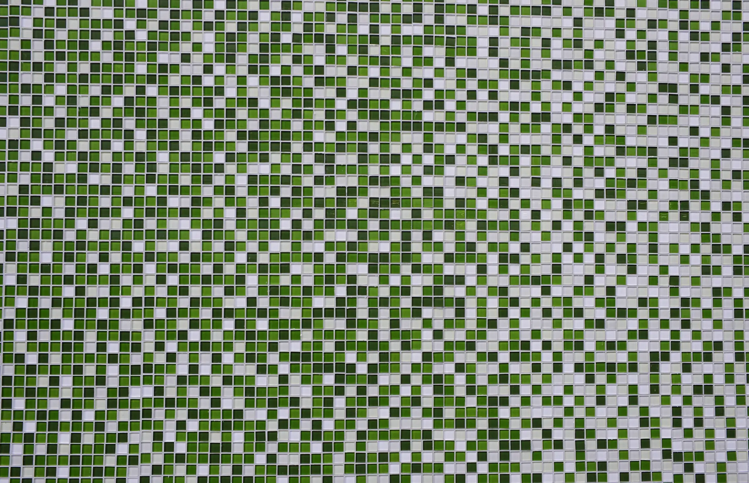 Close-up of StoVentec glass mosaic façade featuring green and white mosaic tiles, showcasing durable rainscreen performance with vibrant design detail.