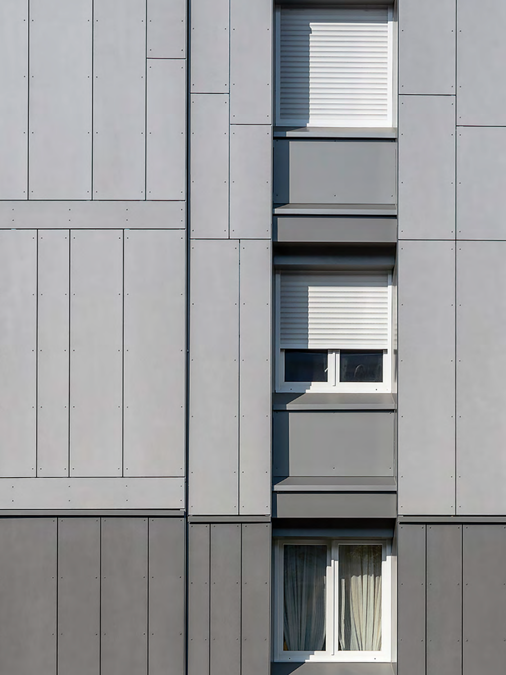 StoVentec rainscreen cladding featuring fiber cement panels in two-tone light and dark concrete gray finishes, providing modern, durable, and weather-resistant exterior siding solutions for commercial and residential projects in Atlantic Canada