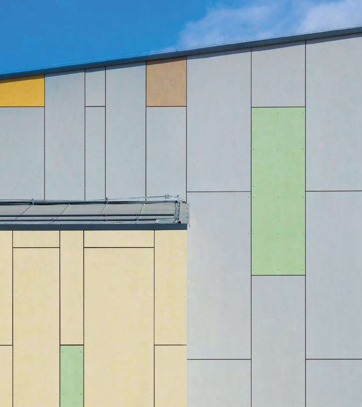 StoVentec rainscreen system with dark fiber cement panels and multicolour accent panels for a high-performance, ventilated facade with bold design appeal in Atlantic Canada