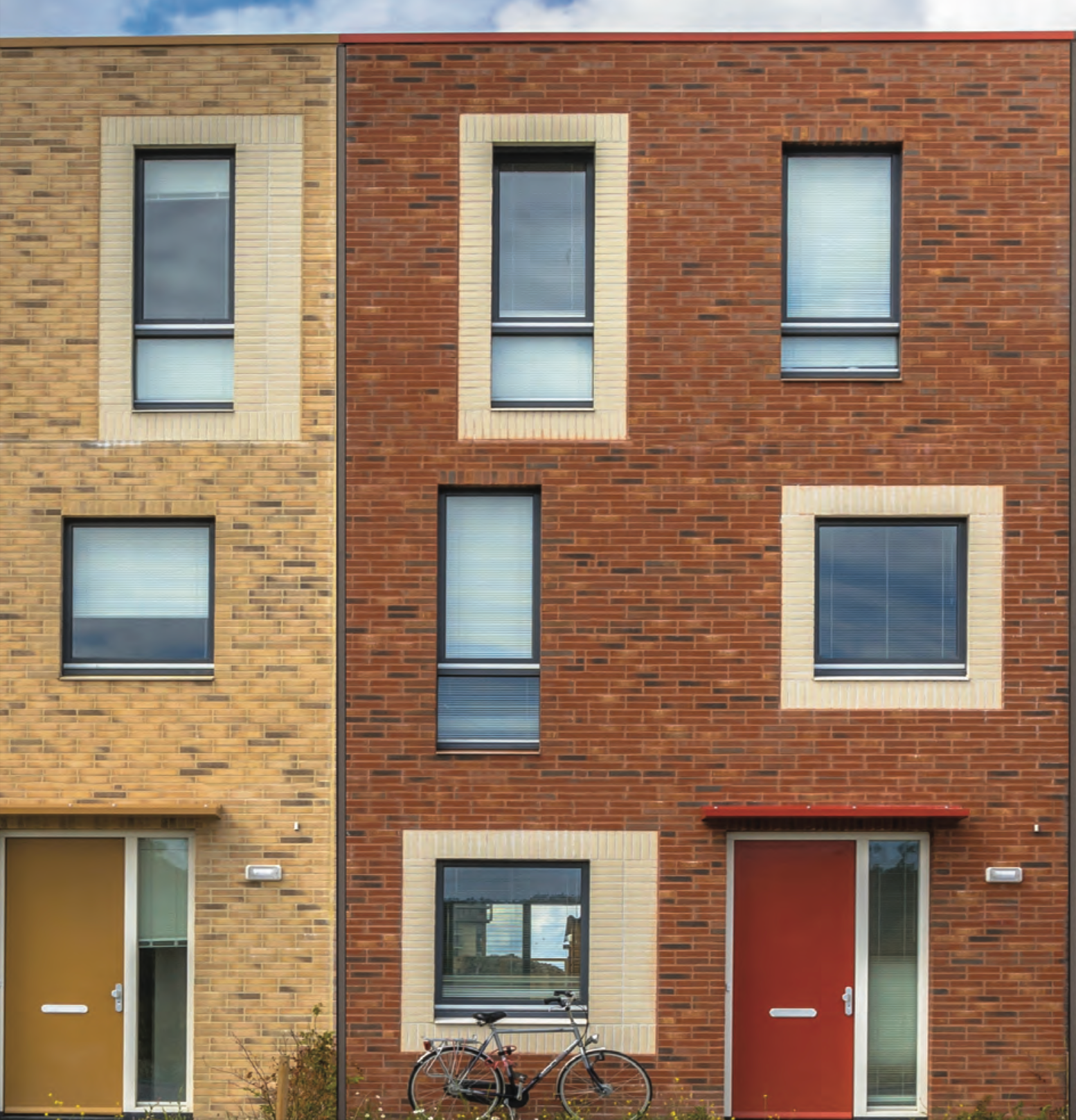 Exterior view of townhouses featuring Sto Masonry Veneer cladding, showcasing durable, high-quality stone veneer finishes designed for long-lasting protection and aesthetic appeal in residential construction
