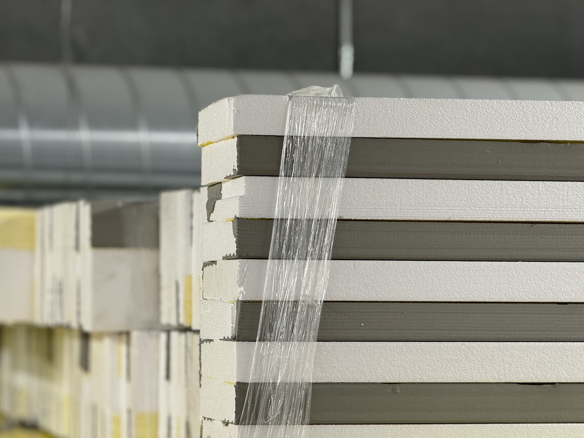 EIFS starter strips showing full 8-foot length with pre-applied basecoat and mesh for exterior wall system installation