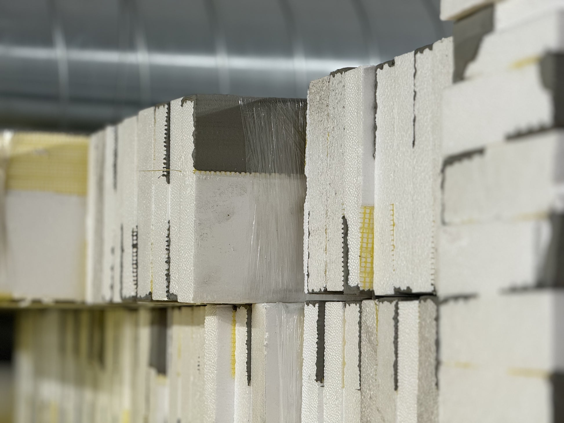 Bundles of EIFS starter strips with pre-applied basecoat and mesh, 8 feet long, ready for fast and consistent system installation