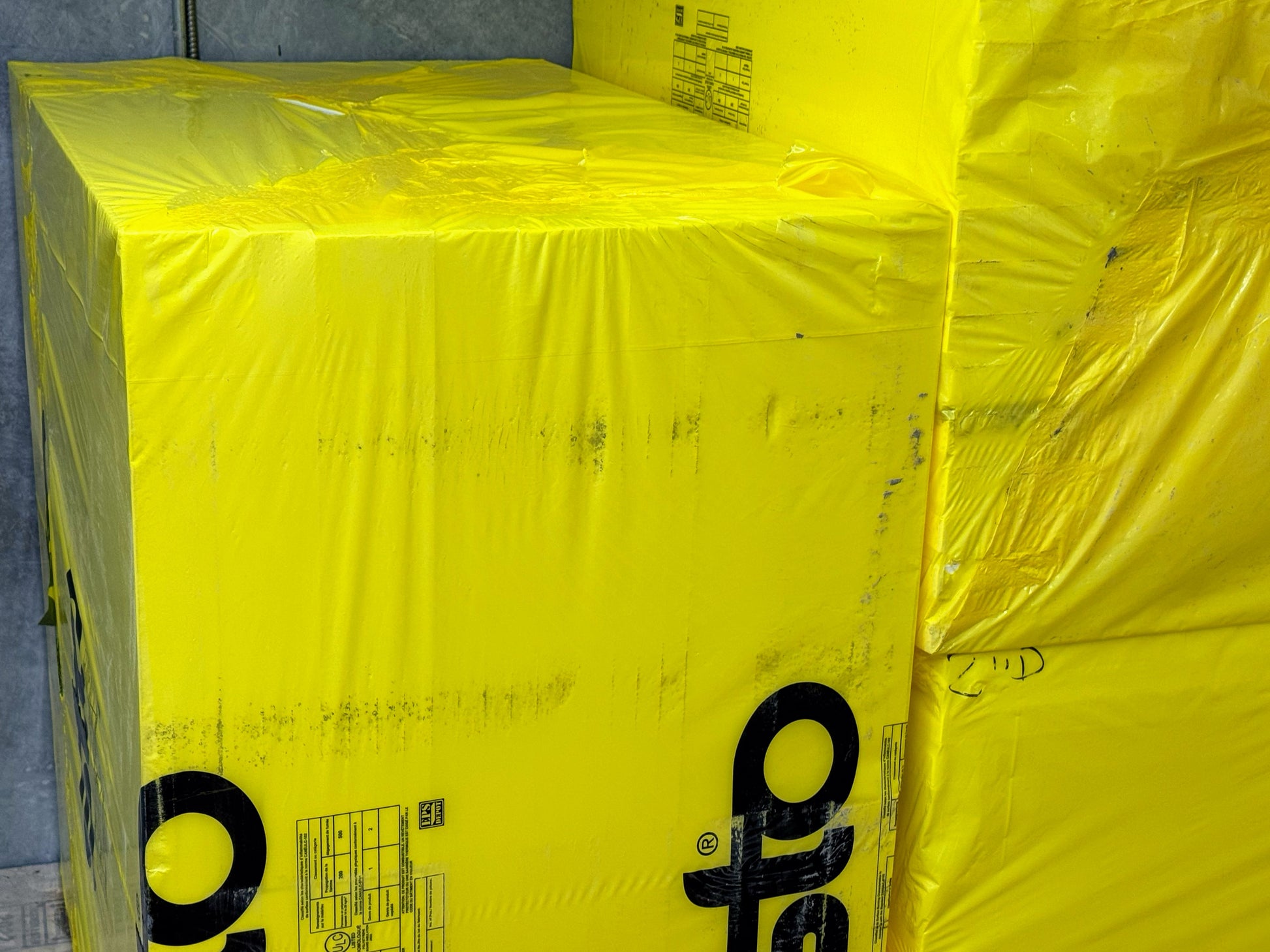 Sto EPS insulation foam board inside yellow packaging with Sto logo, ready for use in exterior insulation and finish systems