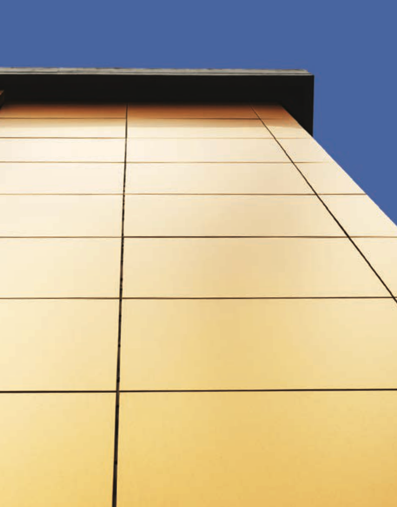 StoColor Metallic Topcoat shimmering on sunlit building corner, viewed from below