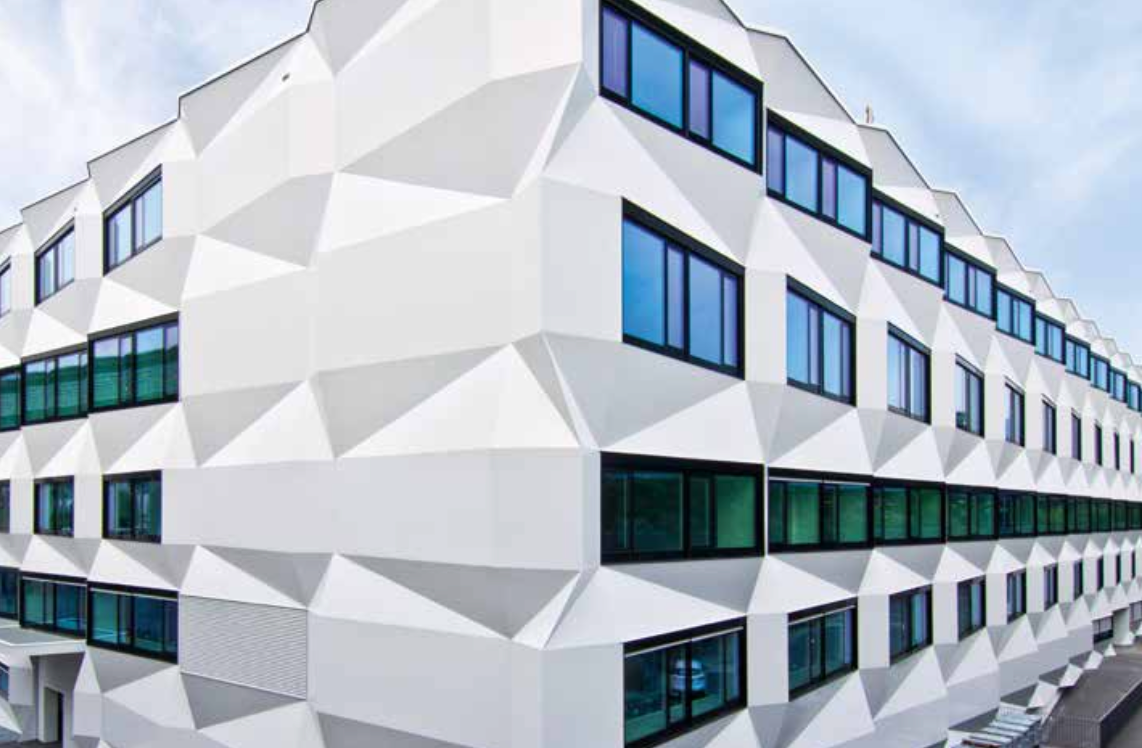 Stoventec stucco system with render finish on geometric building featuring angular 3D triangle shapes
