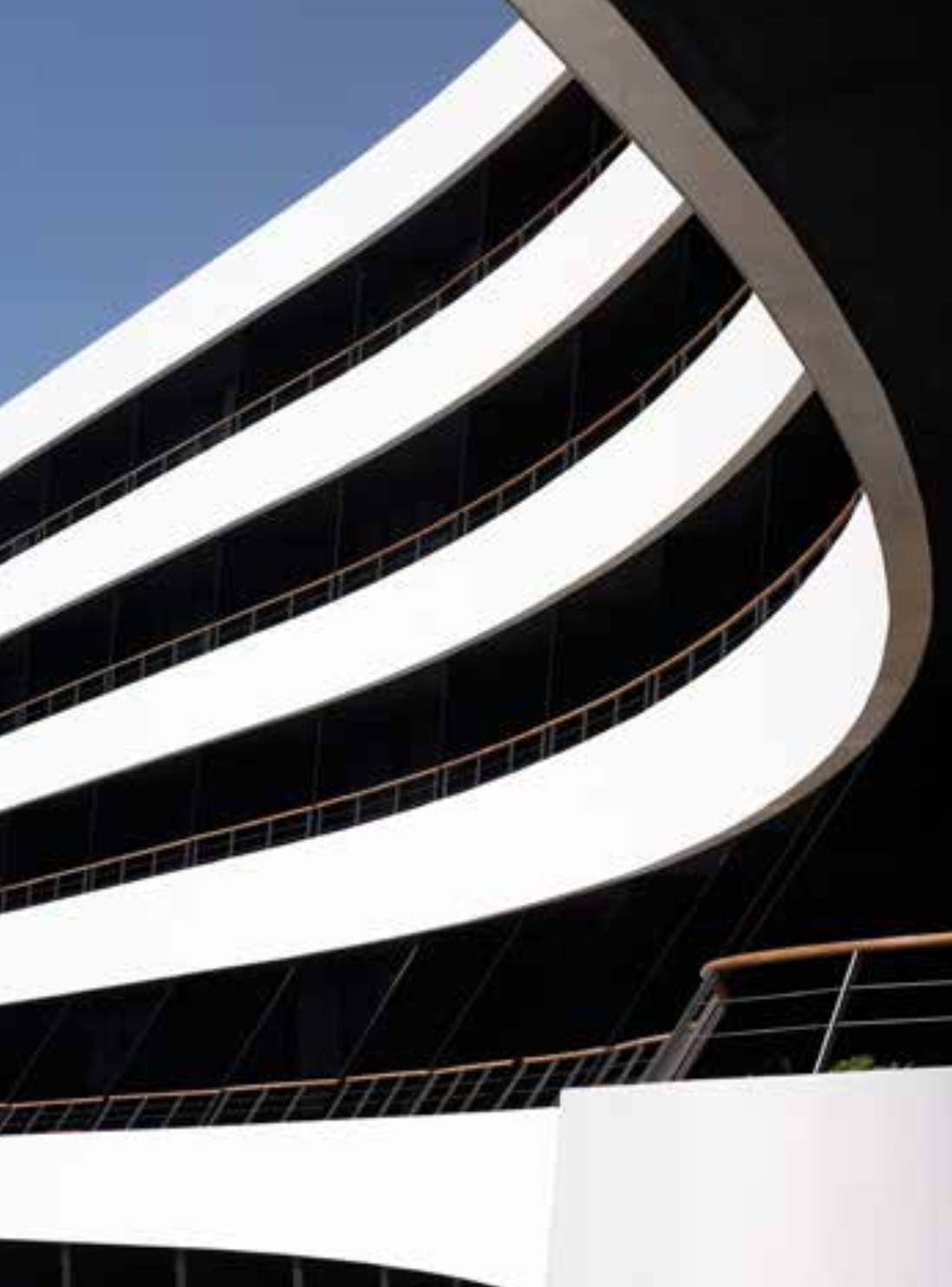 Stoventec stucco system with render finish on swerving levels of open balconies on multi-level building facade