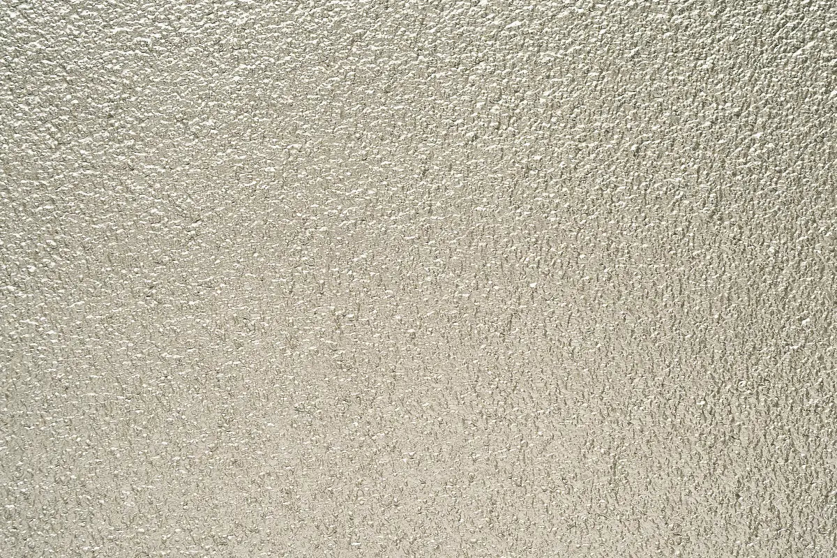 Acrylic stucco texture with metallic topcoat by Sto — close-up image showing reflective, weather-resistant finish ideal for EIFS and rainscreen façades in Atlantic Canada.
