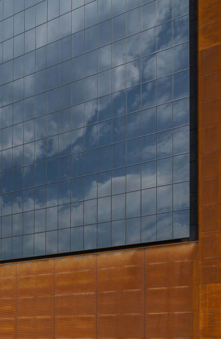 Detailed close-up of StoVentec photovoltaic solar power panel integrated into rainscreen façade system, highlighting solar technology for energy-efficient, sustainable building exteriors.