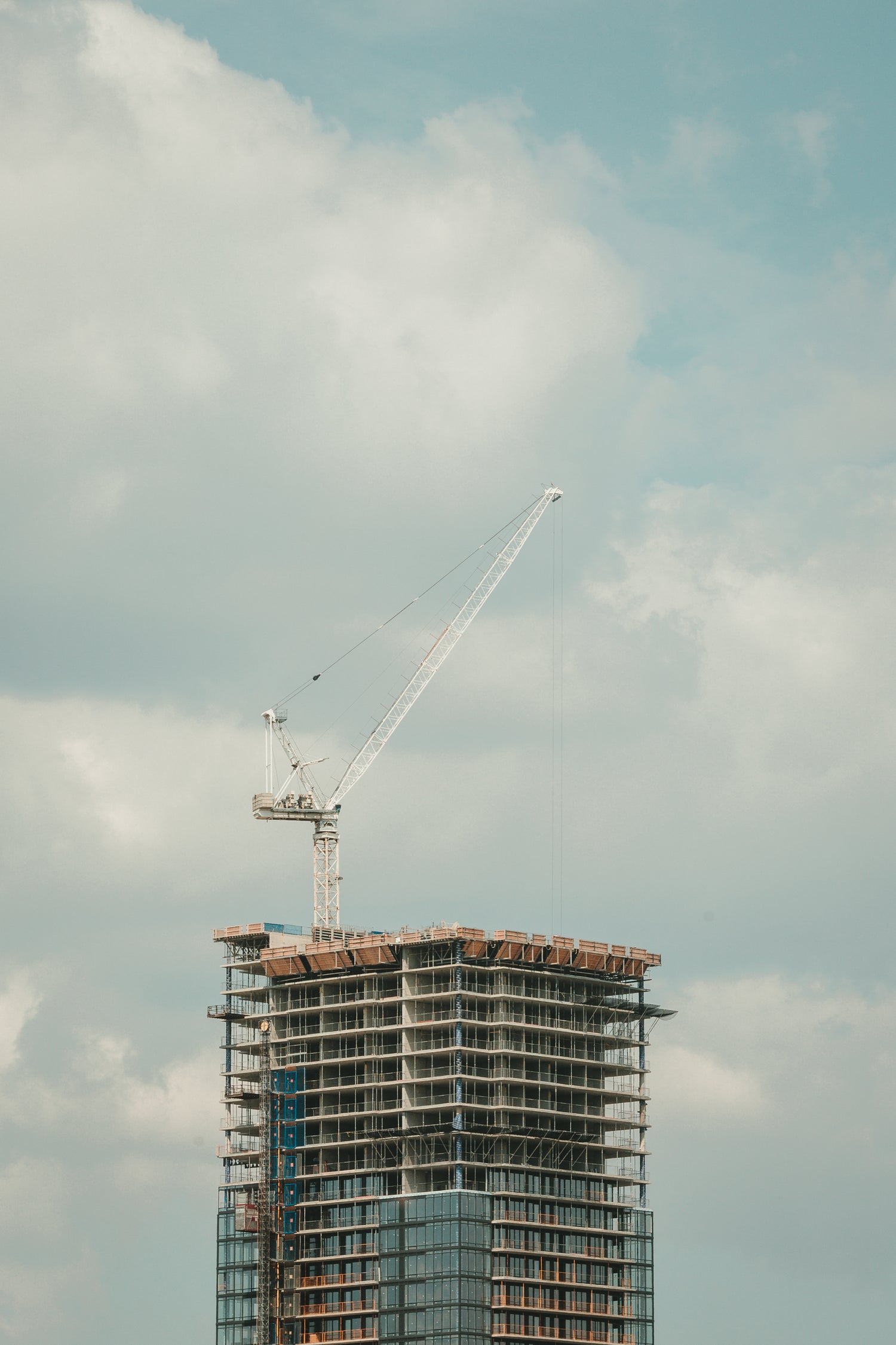 Highrise building under construction with tower crane, showcasing energy-efficient Sto EIFS and rainscreen exterior cladding systems designed for Atlantic Canada's climate.