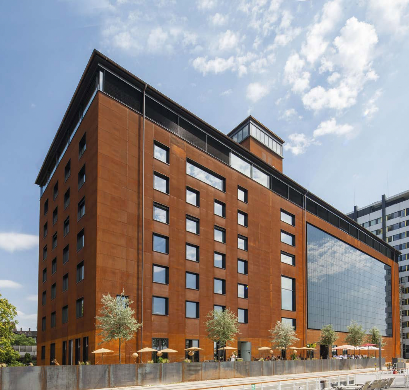 Large American factory-style building retrofitted with StoVentro photovoltaic solar power panels integrated into a rainscreen facade system, optimized for energy efficiency and durability in Atlantic Canada’s coastal climate
