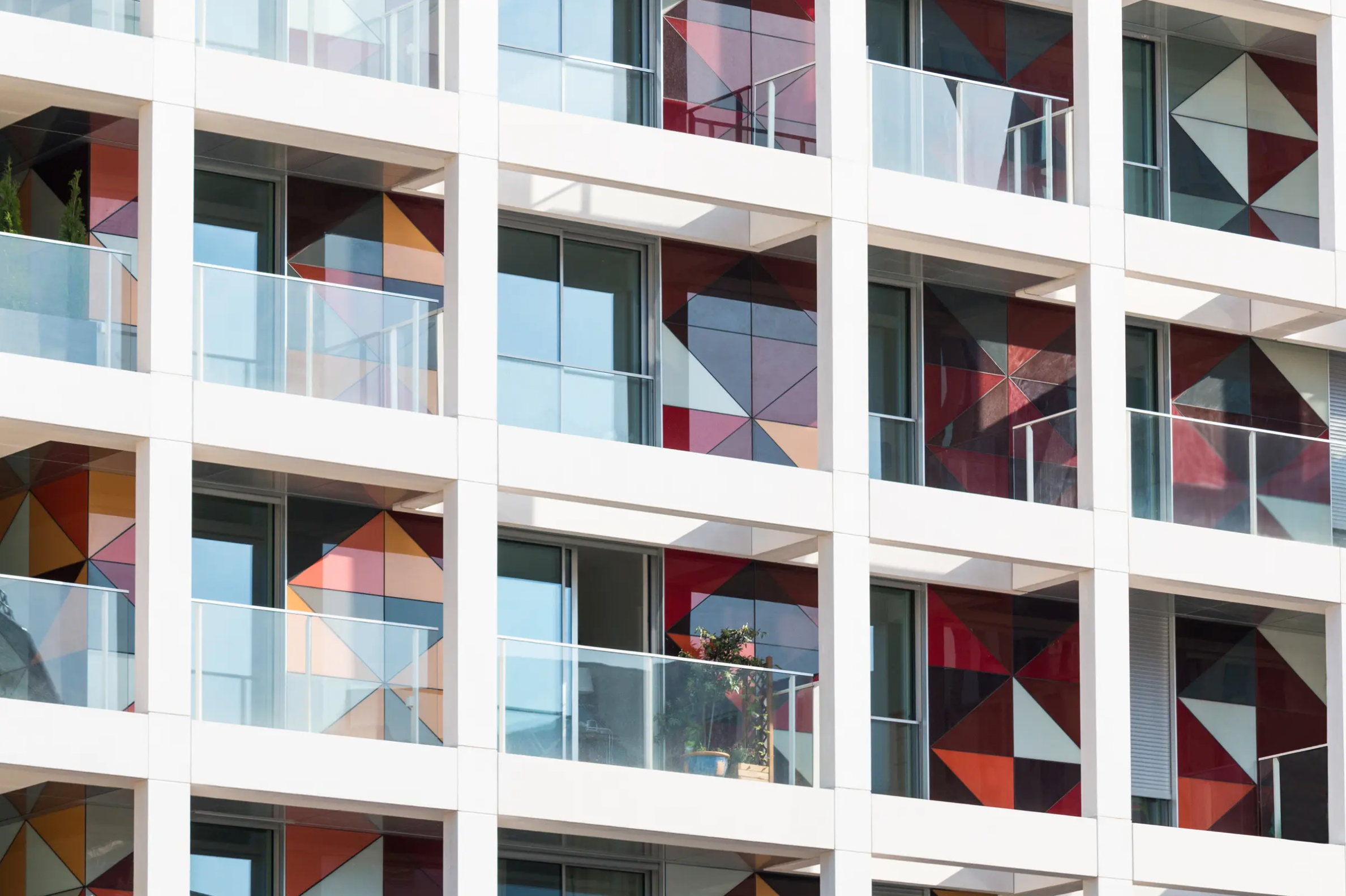 StoVentec glass panel façade featuring multicolour shaded triangle pattern on a luxury condominium exterior, combining high-performance rainscreen design with bold architectural expression.