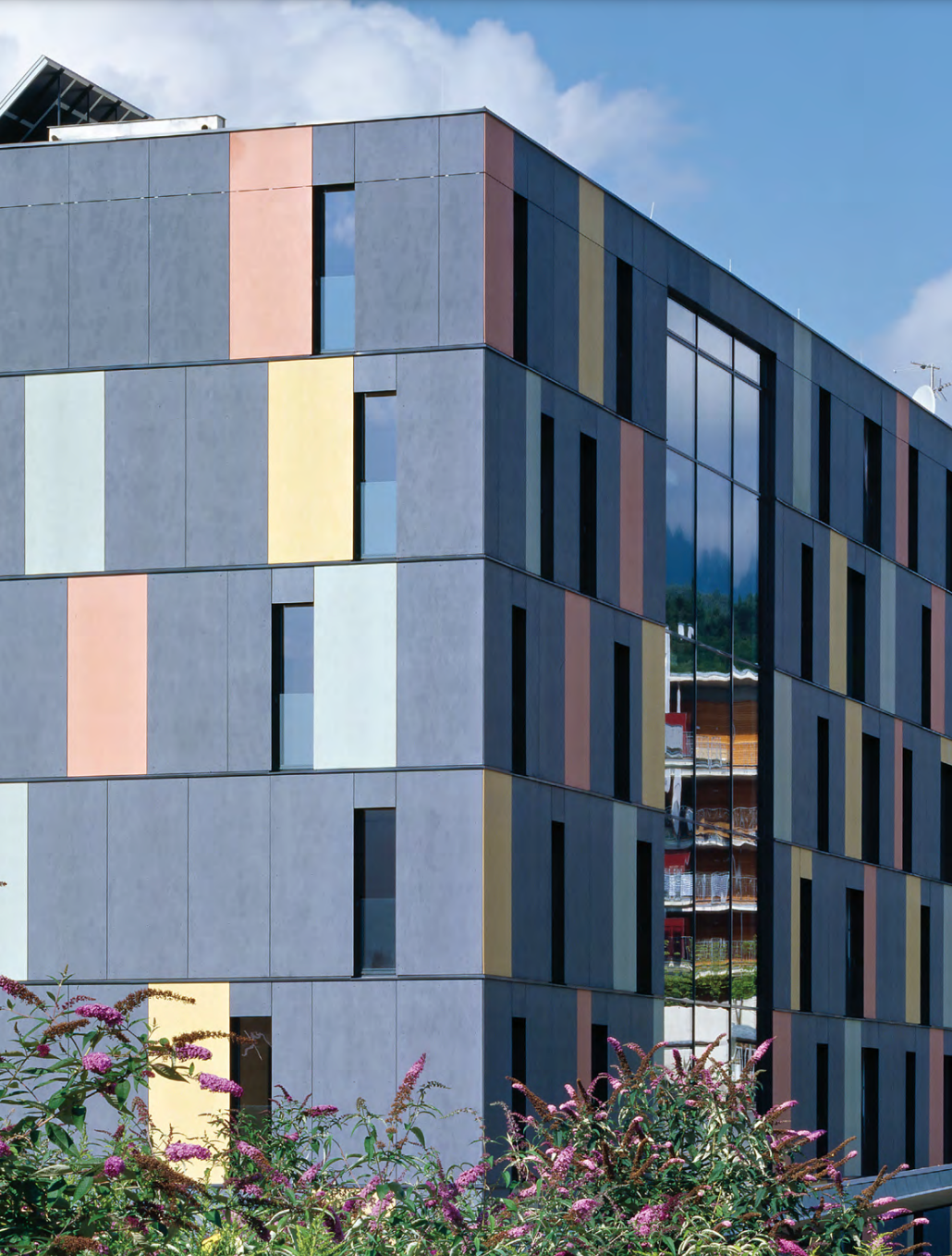 StoVentec rainscreen system with dark fiber cement panels and multicolour accent panels for a high-performance, ventilated façade with bold design appeal in Atlantic Canada