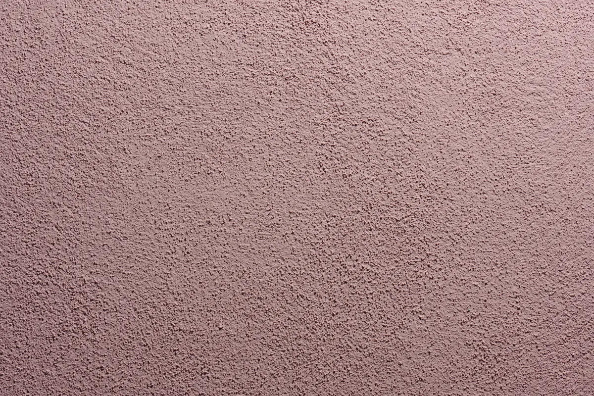 Durable, breathable acrylic stucco for EIFS and rainscreen exteriors. Close-up of Sto Signature Stucco finish with fine texture in pink-beige color.