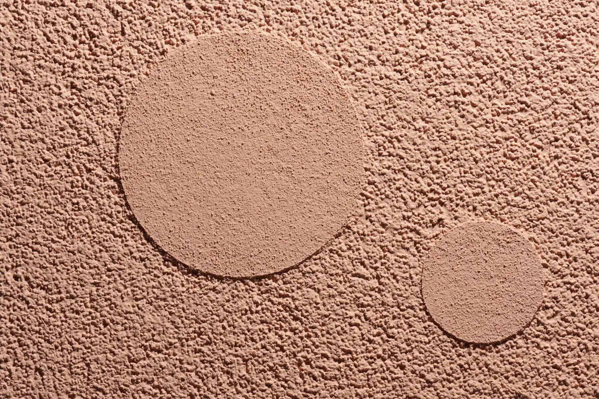 Close-up of Sto acrylic stucco finish showing smooth circular texture details on a single surface — versatile multi-texture design for EIFS and rainscreen façades in Atlantic Canada.