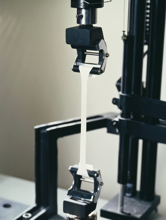 Testing machine measuring flexibility and stretch performance of StoColor Silcolastic elastomeric paint under stress conditions
