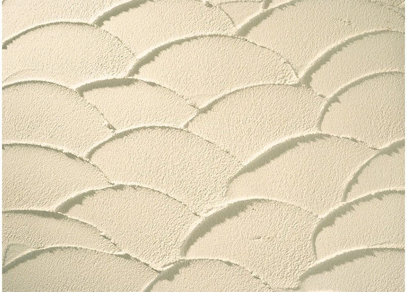 Close up of Stolit Freeform acrylic stucco plaster finish showing unique curved pattern texture