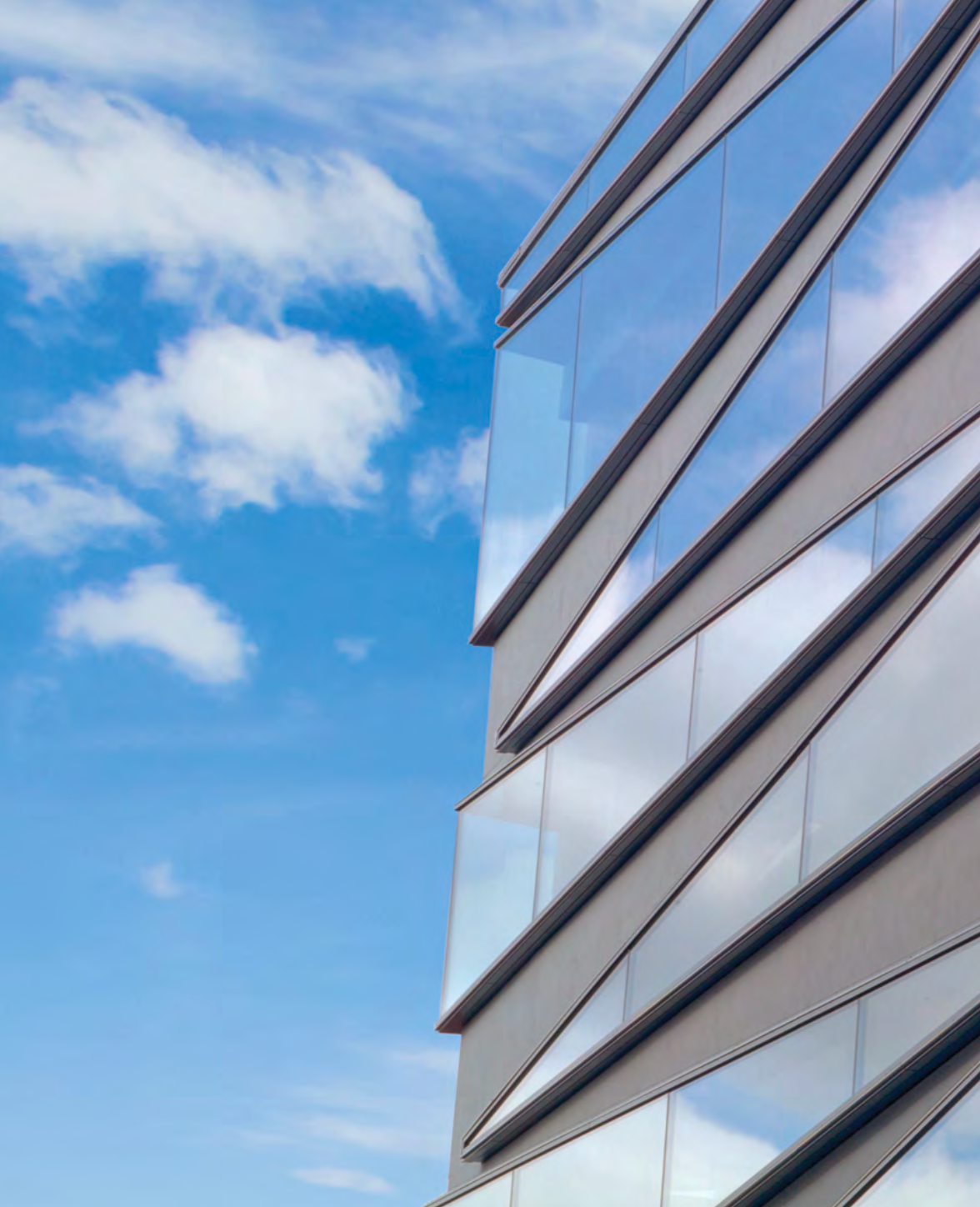Stoventec Glass Render stucco cladding with angled window design on building side elevation